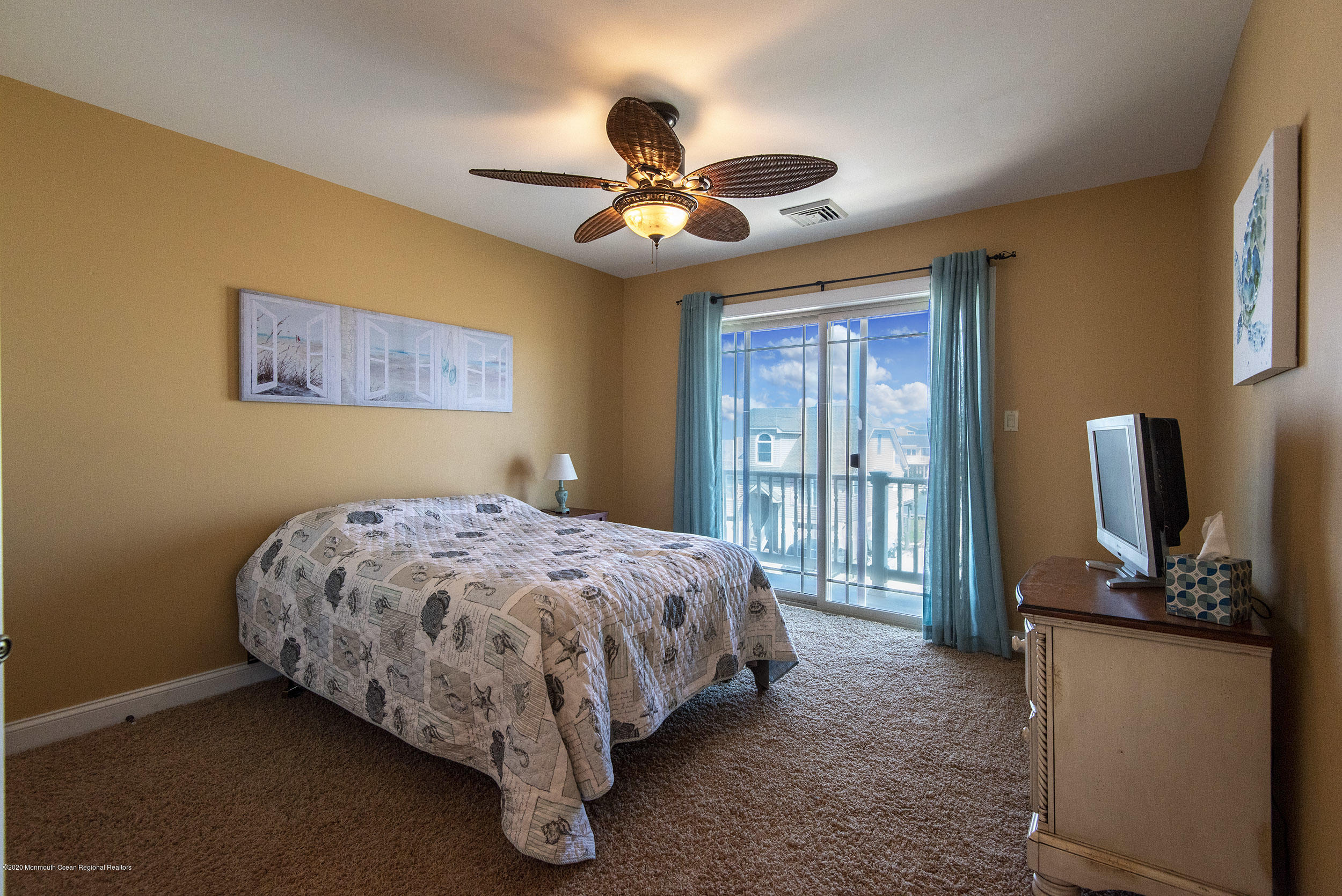 214 Heron Road Tuckerton, NJ 08087 - Photo 20 of 31 a bedroom with a bed dresser and a flat tv screen