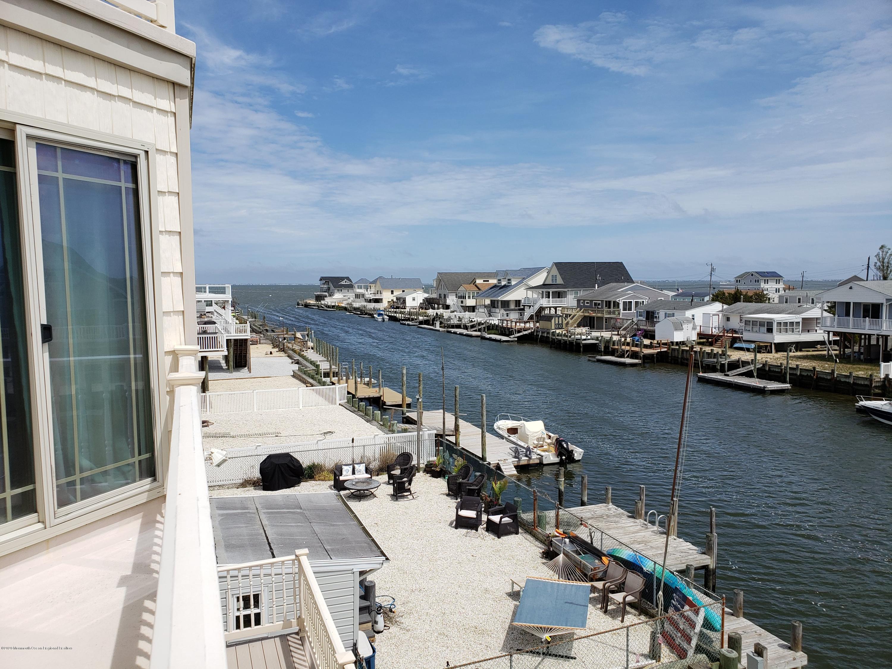 214 Heron Road Tuckerton, NJ 08087 - Photo 26 of 31 a view of a balcony with chairs and wooden floor