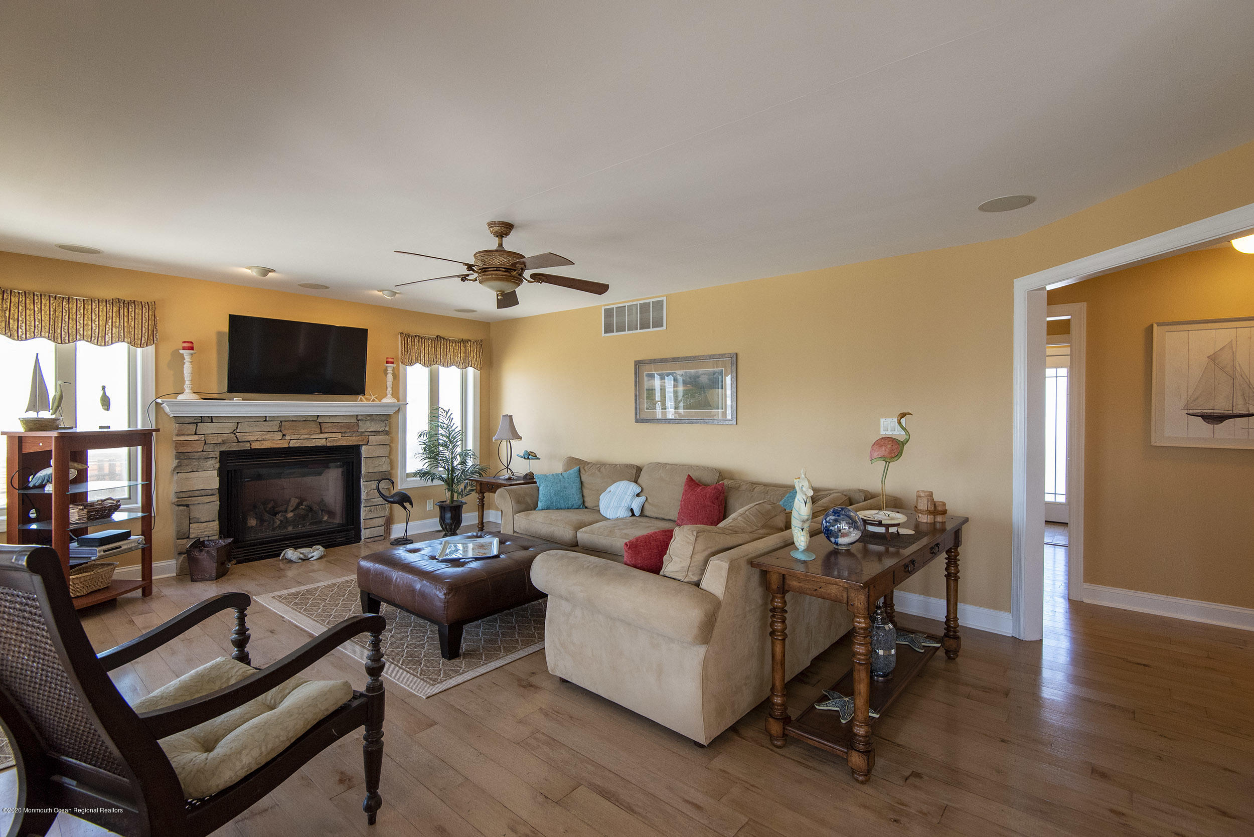214 Heron Road Tuckerton, NJ 08087 - Photo 5 of 31 a living room with furniture a fireplace and a flat screen tv