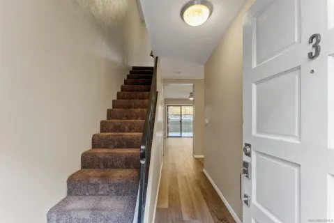 a view of entryway and hall with wooden floor