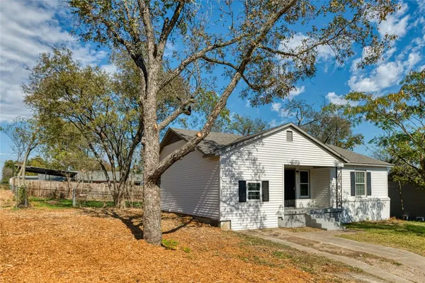 a view of a house with snow on the tree