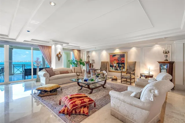 a view of a dining room with furniture a chandelier and wooden floor