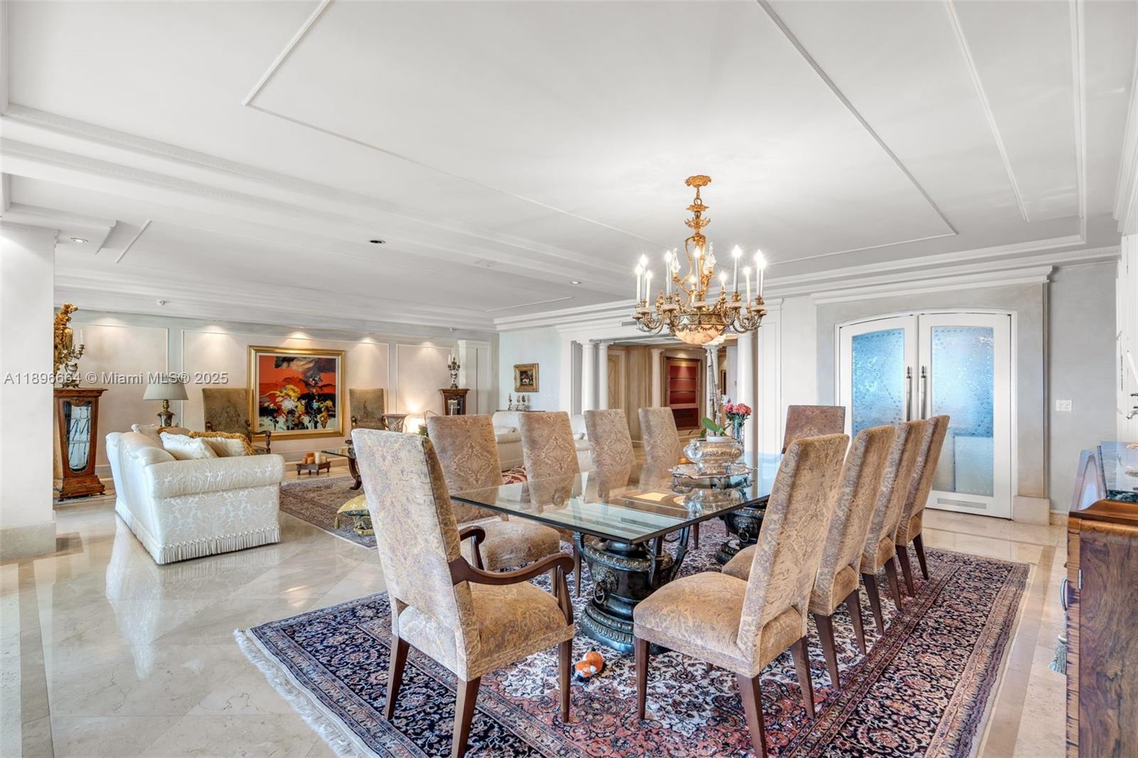 445 Grand Bay Drive, Unit 1001 Key Biscayne, FL 33149 - Photo 20 of 57 a view of a dining room with furniture a chandelier and wooden floor
