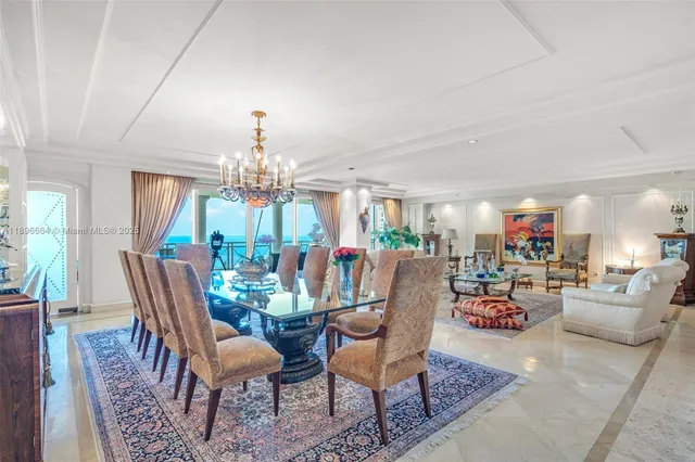 a living room with furniture large window and wooden floor