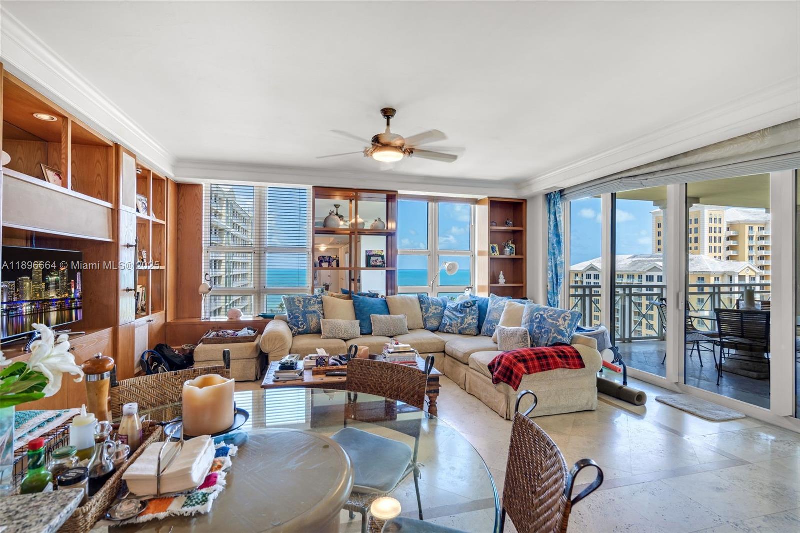 445 Grand Bay Drive, Unit 1001 Key Biscayne, FL 33149 - Photo 23 of 57 a living room with furniture large window and wooden floor