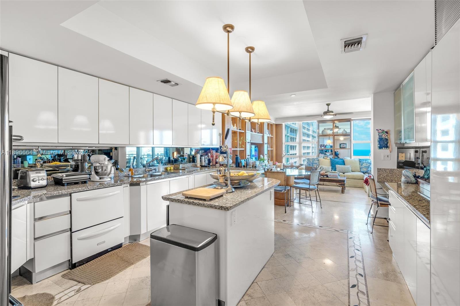 445 Grand Bay Drive, Unit 1001 Key Biscayne, FL 33149 - Photo 25 of 57 a kitchen with counter top space a sink appliances and cabinets