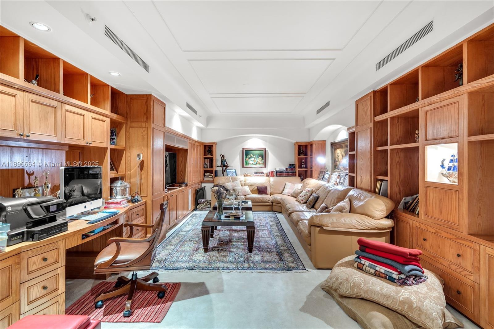 445 Grand Bay Drive, Unit 1001 Key Biscayne, FL 33149 - Photo 34 of 57 a living room with furniture gym equipment and a large window