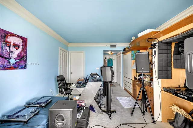 a bedroom with a bed a large window with table and chairs