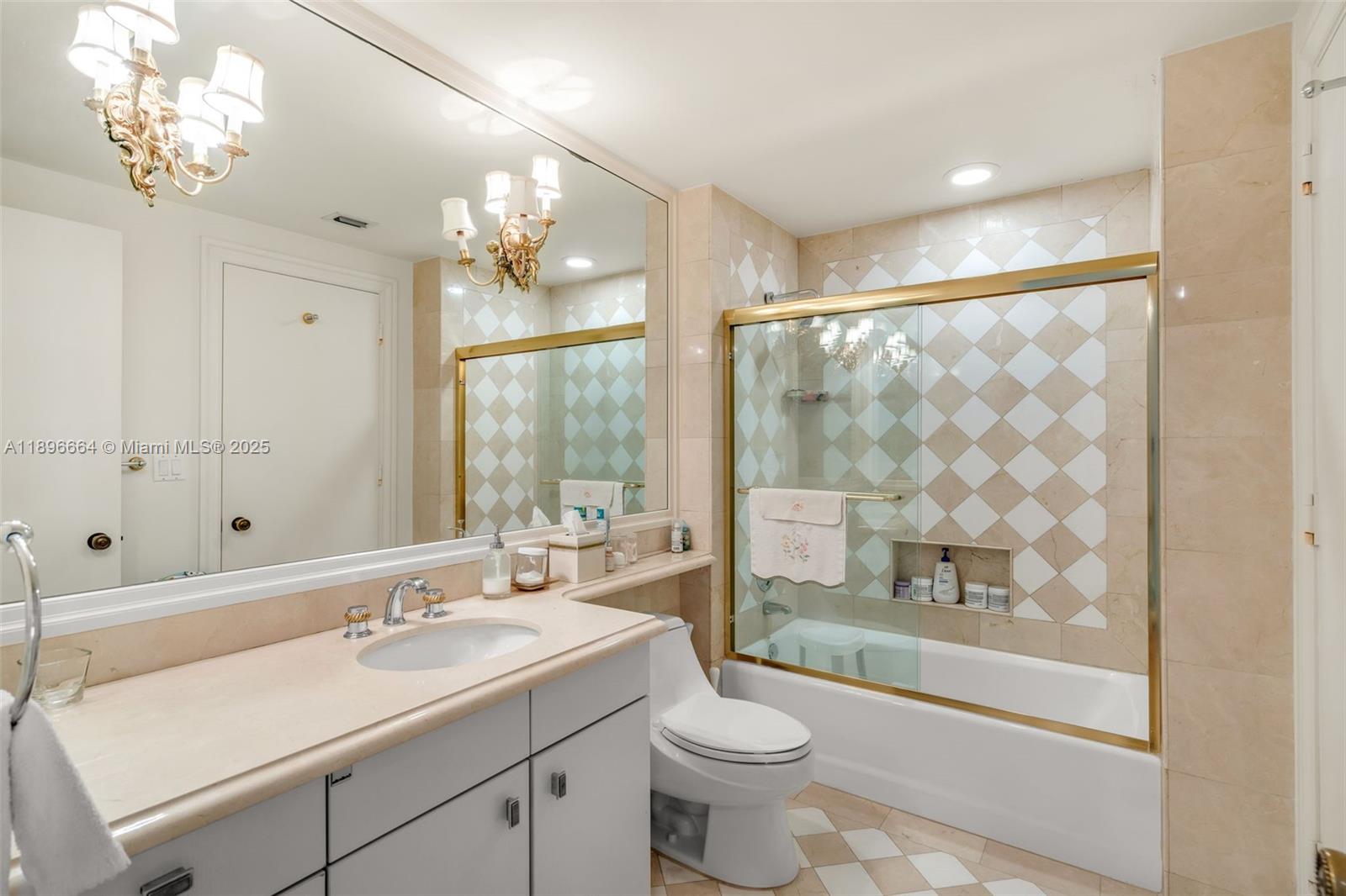 445 Grand Bay Drive, Unit 1001 Key Biscayne, FL 33149 - Photo 38 of 57 a bathroom with a toilet a sink a large mirror and shower