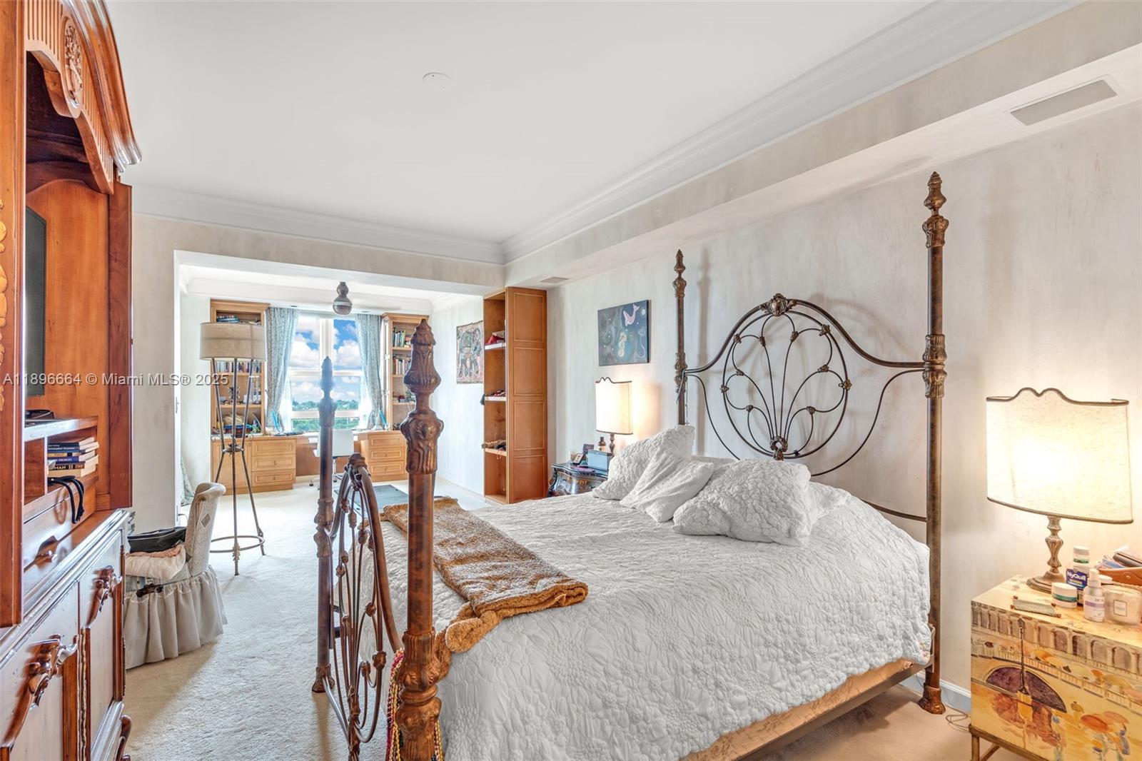 445 Grand Bay Drive, Unit 1001 Key Biscayne, FL 33149 - Photo 41 of 57 a bedroom with a bed a large window with table and chairs