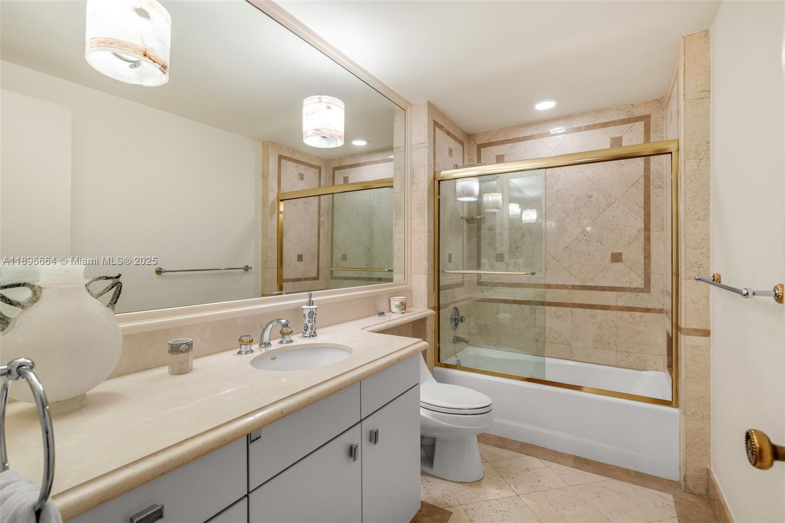 445 Grand Bay Drive, Unit 1001 Key Biscayne, FL 33149 - Photo 45 of 57 a bathroom with a granite countertop sink toilet and shower