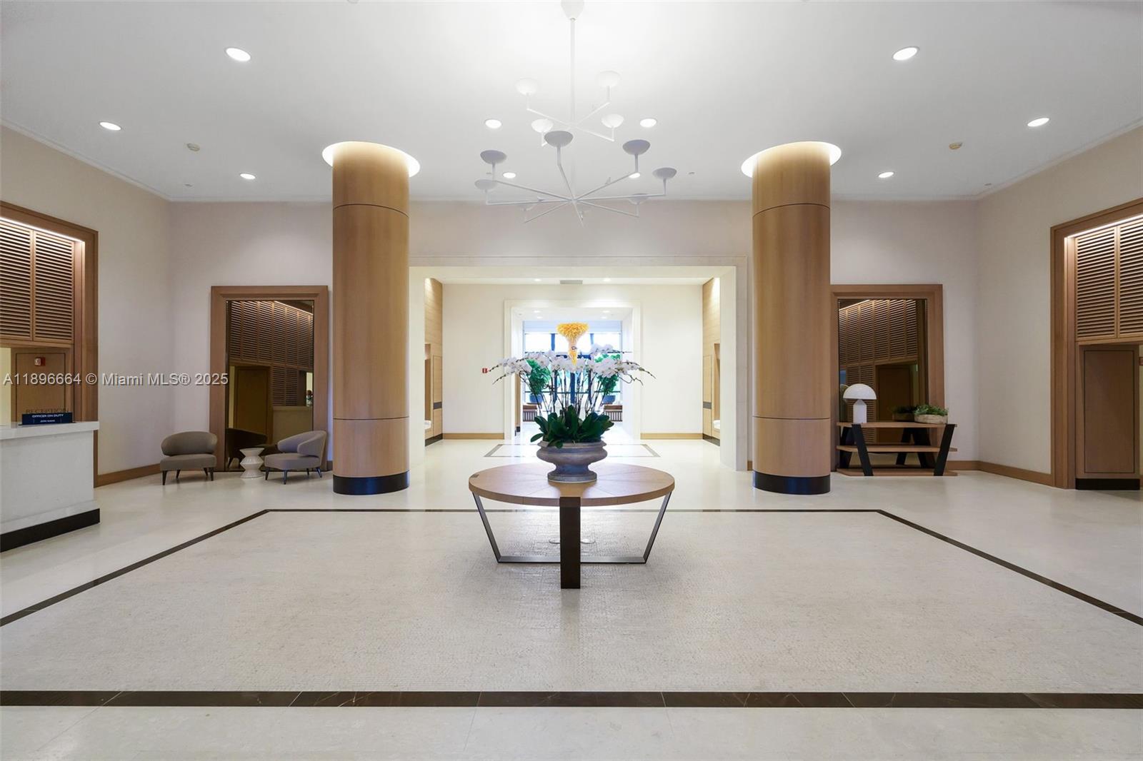 445 Grand Bay Drive, Unit 1001 Key Biscayne, FL 33149 - Photo 50 of 57 a living room with furniture and a chandelier