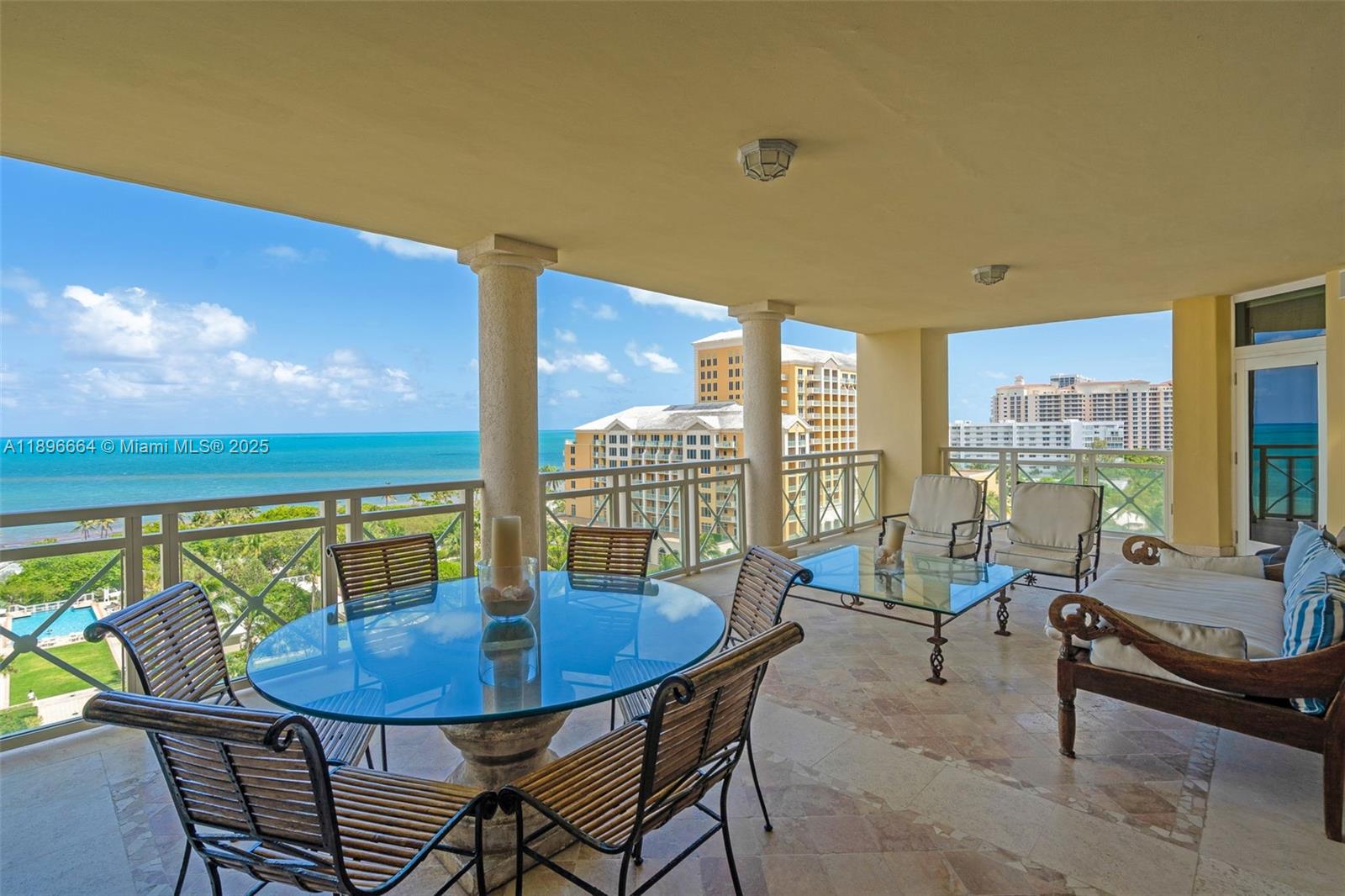 445 Grand Bay Drive, Unit 1001 Key Biscayne, FL 33149 - Photo 7 of 57 a view of a dining room with furniture large windows and wooden floor