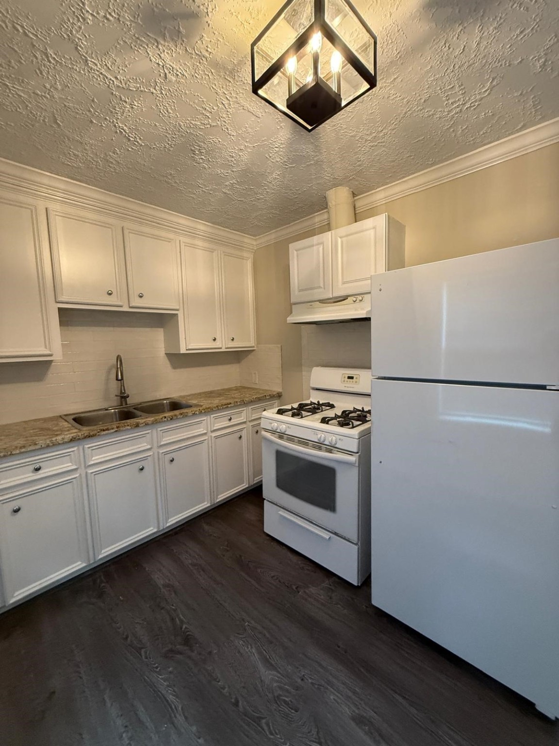 731 Columbia Street, Unit 1 Houston, TX 77007 - Photo 3 of 8 a kitchen with stainless steel appliances a stove a sink and white cabinets