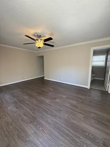 a view of an empty room with wooden floor