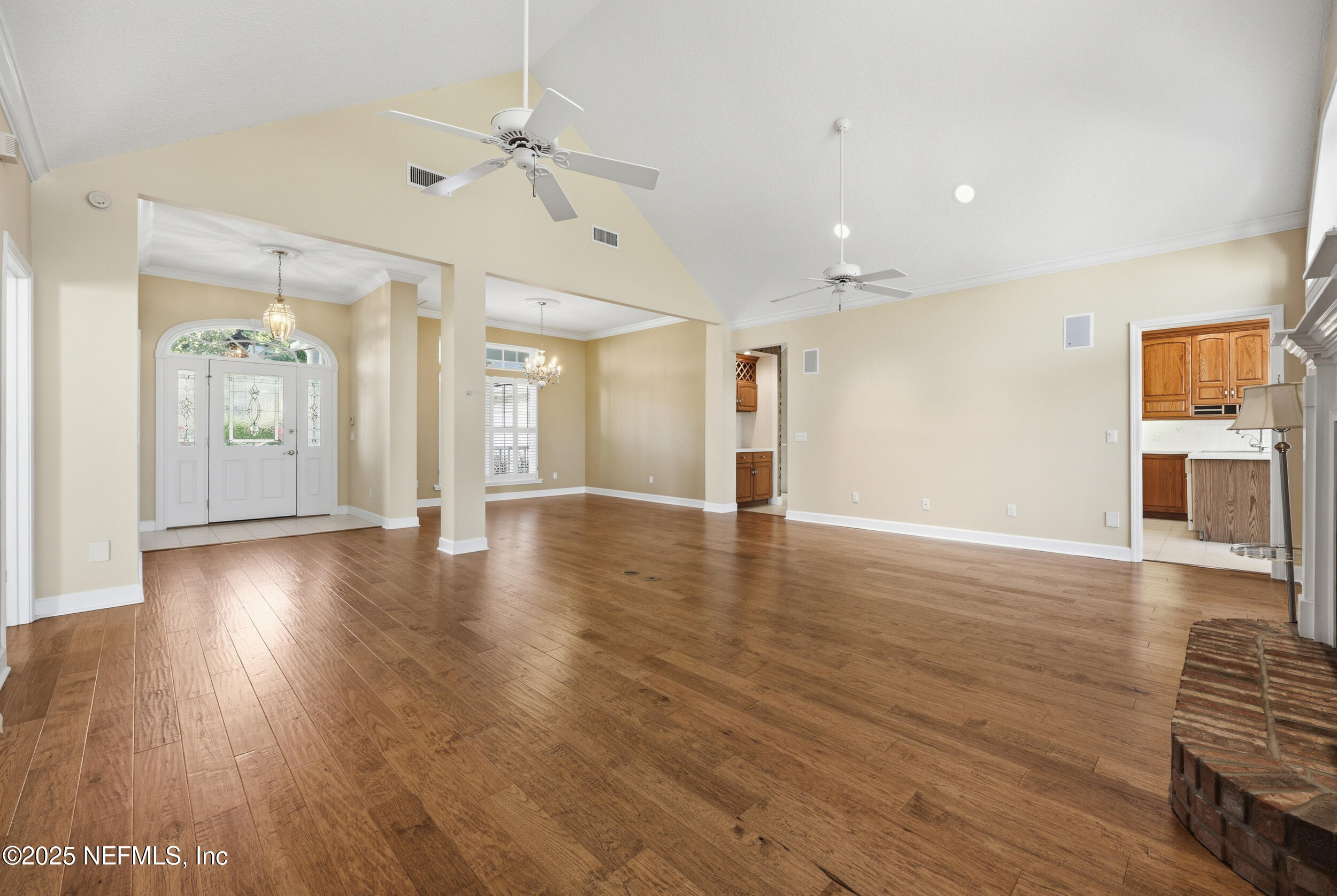 2332 Fiddlers Lane Atlantic Beach, FL 32233 - Photo 15 of 56 an empty room with wooden floor and a kitchen