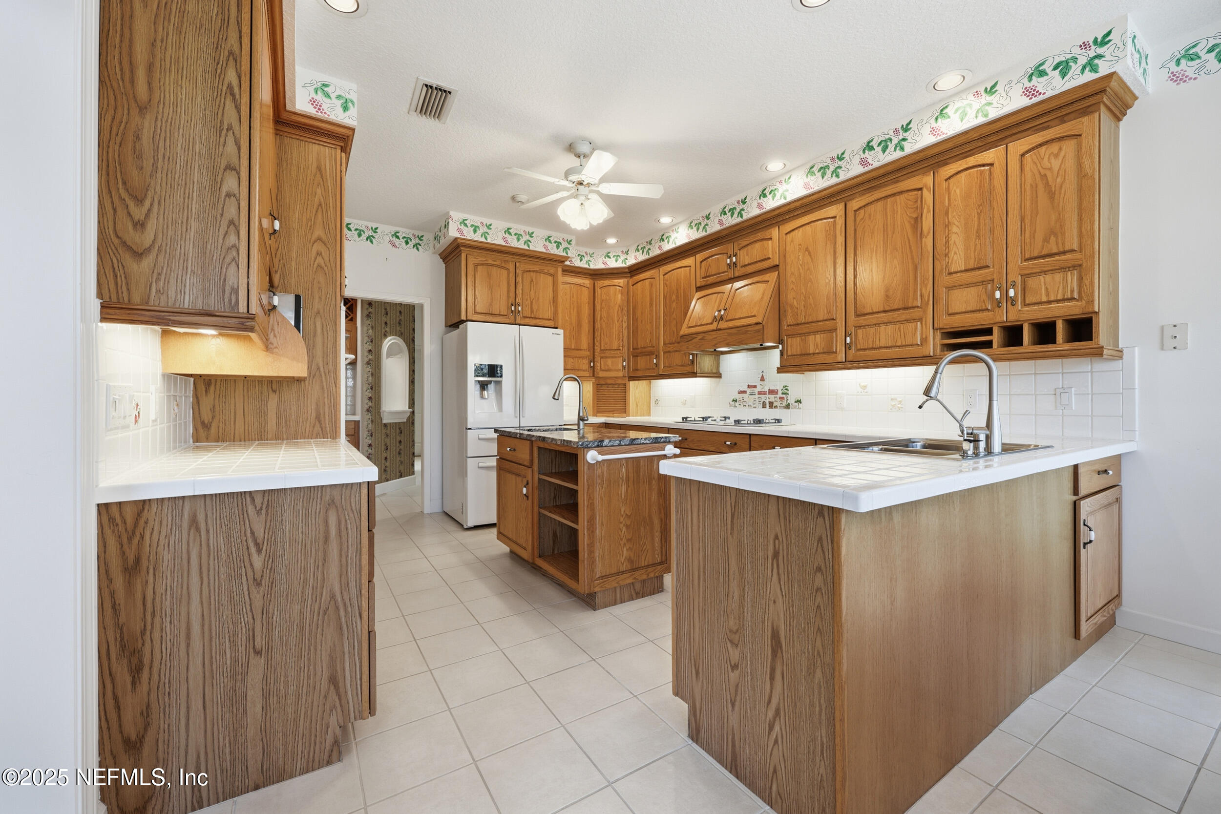 2332 Fiddlers Lane Atlantic Beach, FL 32233 - Photo 16 of 56 a kitchen with kitchen island granite countertop a sink counter top space and appliances