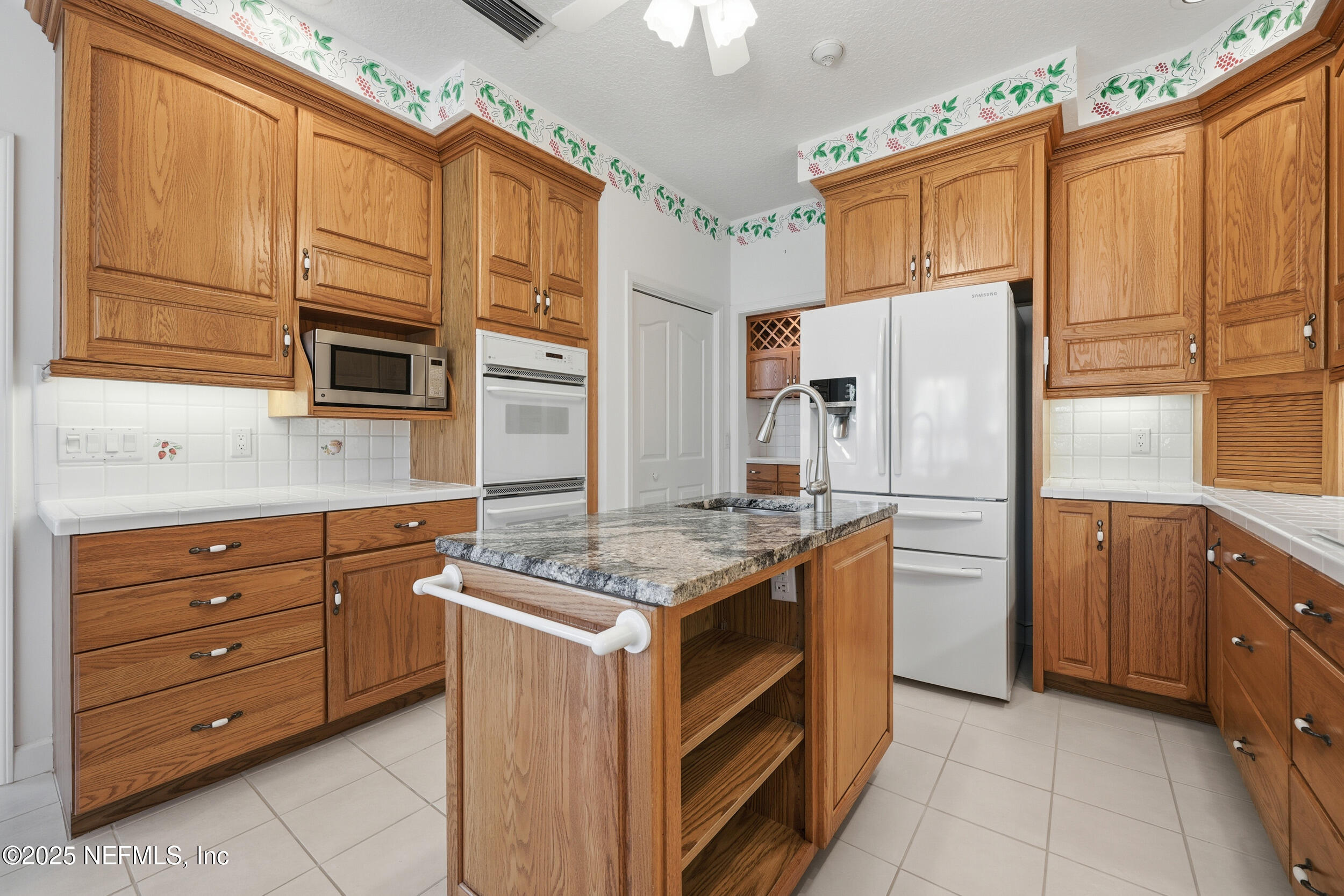 2332 Fiddlers Lane Atlantic Beach, FL 32233 - Photo 18 of 56 a kitchen with stainless steel appliances granite countertop a refrigerator and a stove top oven