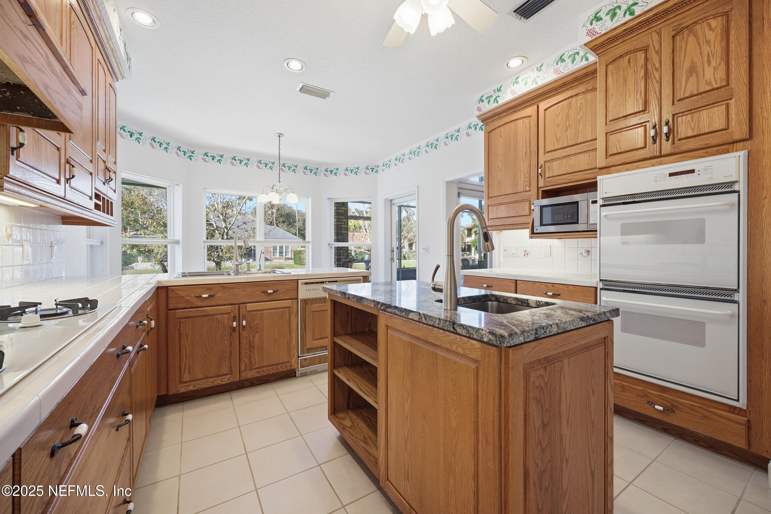 2332 Fiddlers Lane Atlantic Beach, FL 32233 - Photo 19 of 56 a kitchen with granite countertop a sink stove and refrigerator