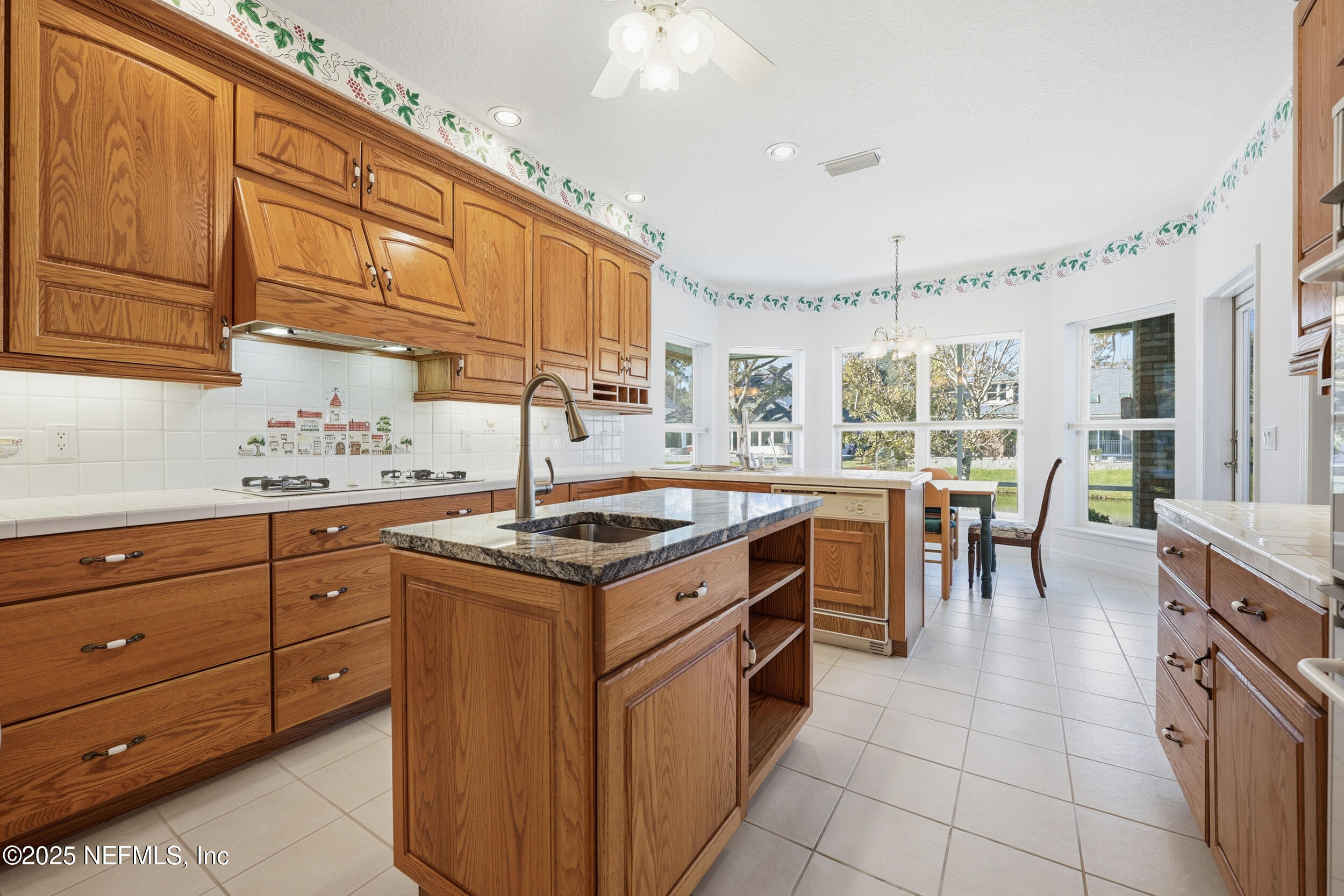 2332 Fiddlers Lane Atlantic Beach, FL 32233 - Photo 20 of 56 a kitchen with granite countertop a sink a counter top space appliances and cabinets