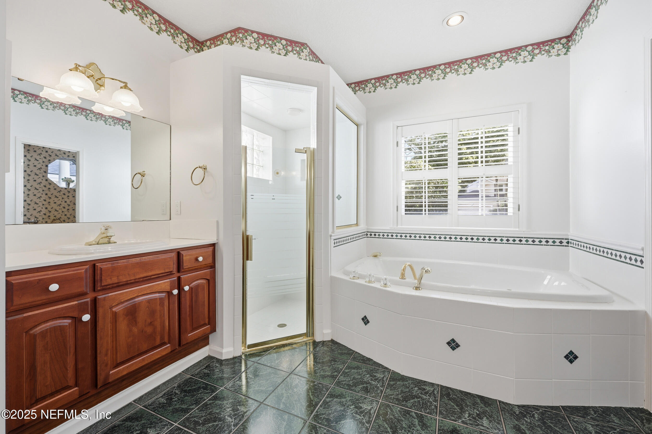 2332 Fiddlers Lane Atlantic Beach, FL 32233 - Photo 29 of 56 a bathroom with a tub a sink shower and mirror
