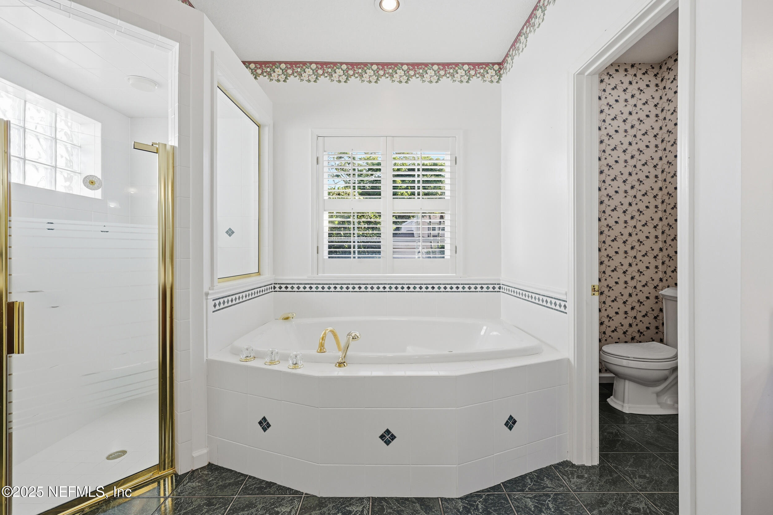 2332 Fiddlers Lane Atlantic Beach, FL 32233 - Photo 30 of 56 a bathroom with a tub a toilet and a shower