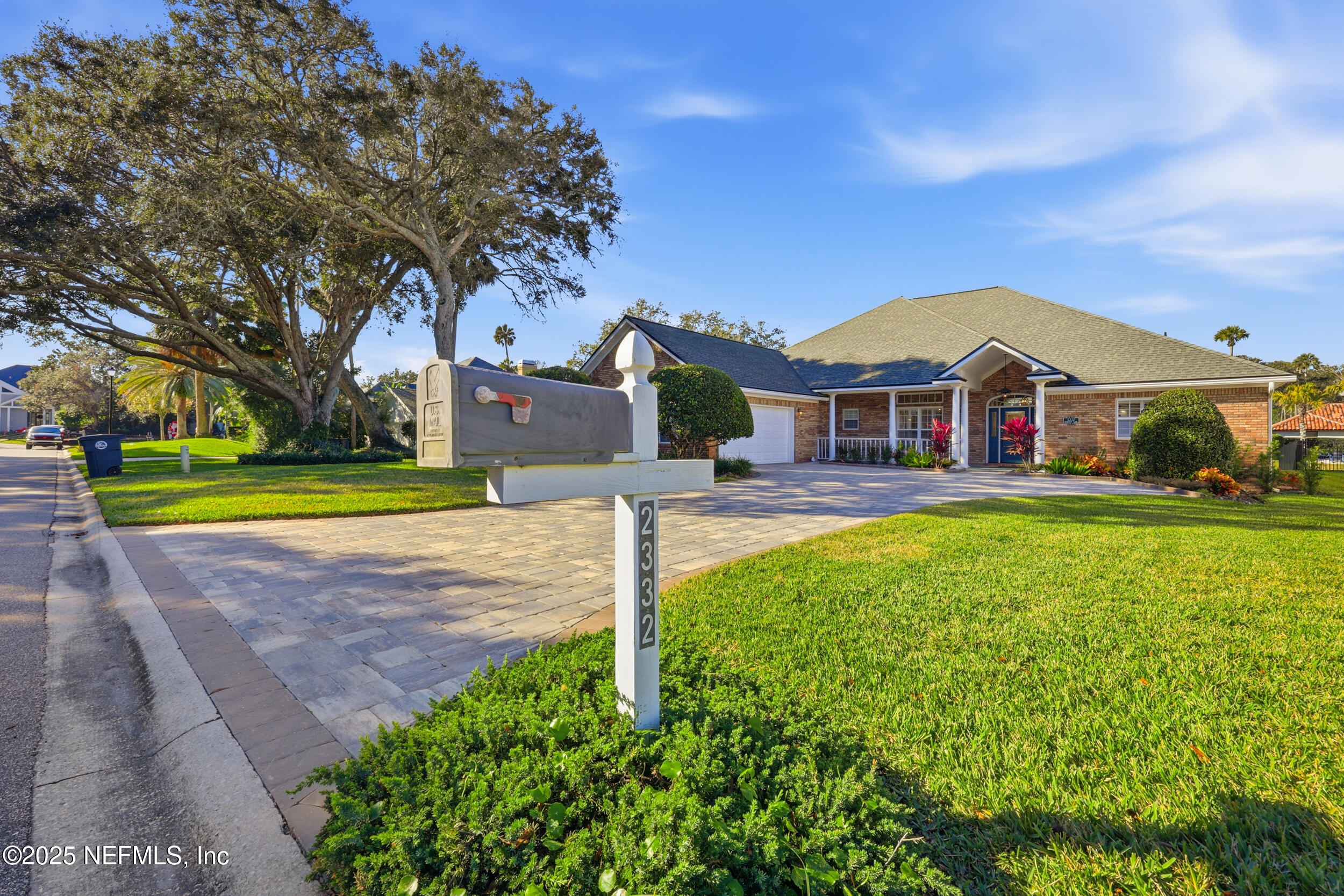 2332 Fiddlers Lane Atlantic Beach, FL 32233 - Photo 55 of 56 a front view of a house with a yard and fountain