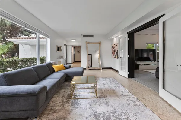 a living room with furniture and a large window