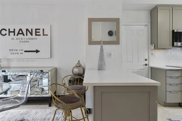 a kitchen with a sink cabinets and wooden floor