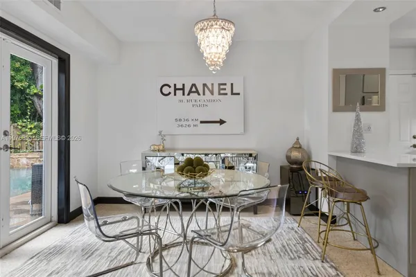 a view of a dining room with furniture wooden floor and a chandelier