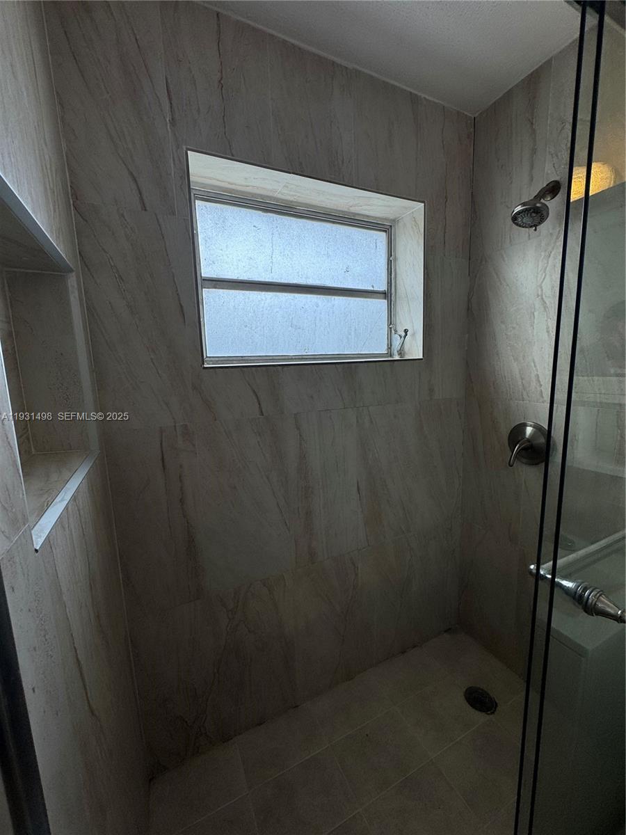 2146 Northwest 18th Terrace, Unit B Miami, FL 33125 - Photo 11 of 19 a bathroom with a shower
