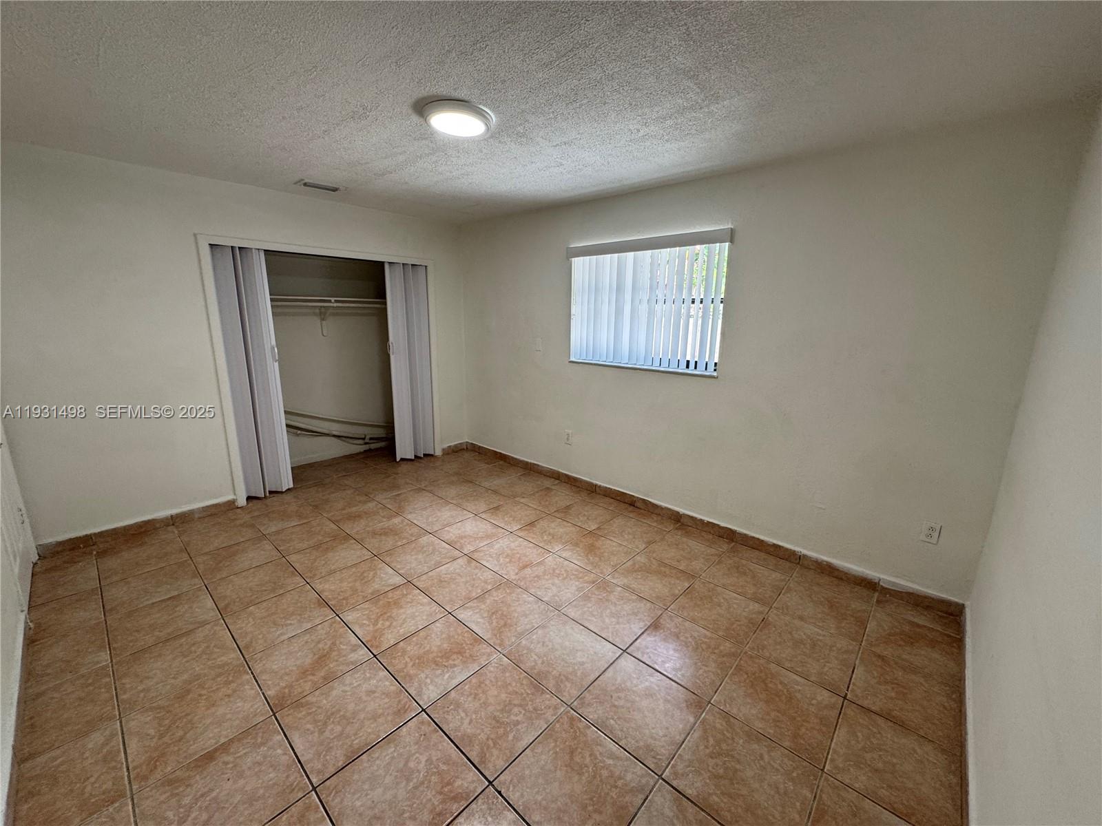 2146 Northwest 18th Terrace, Unit B Miami, FL 33125 - Photo 13 of 19 an empty room with windows