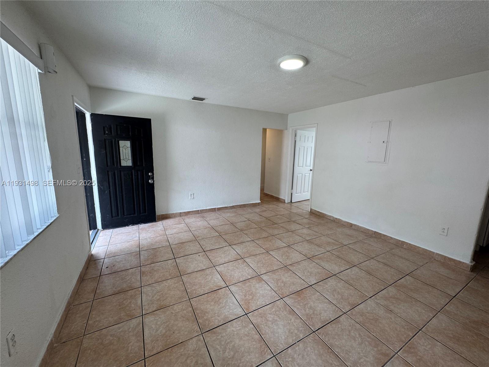 2146 Northwest 18th Terrace, Unit B Miami, FL 33125 - Photo 3 of 19 a view of an empty room and closet area