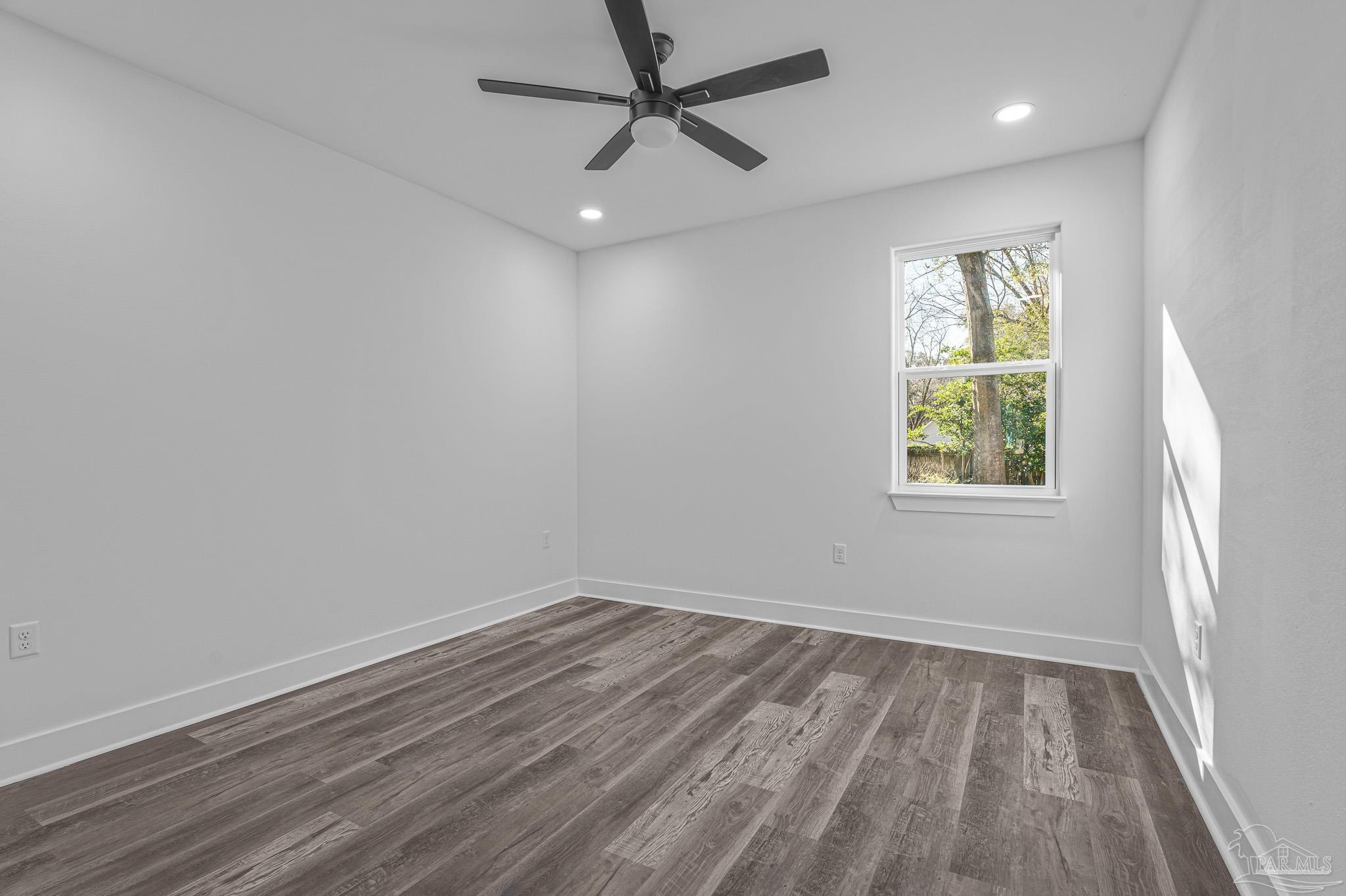 5005 Saufley Field Road Pensacola, FL 32526 - Photo 19 of 27 an empty room with a window and a fan
