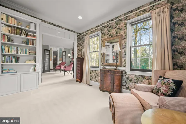 a bedroom with bed and a night stand next to a window