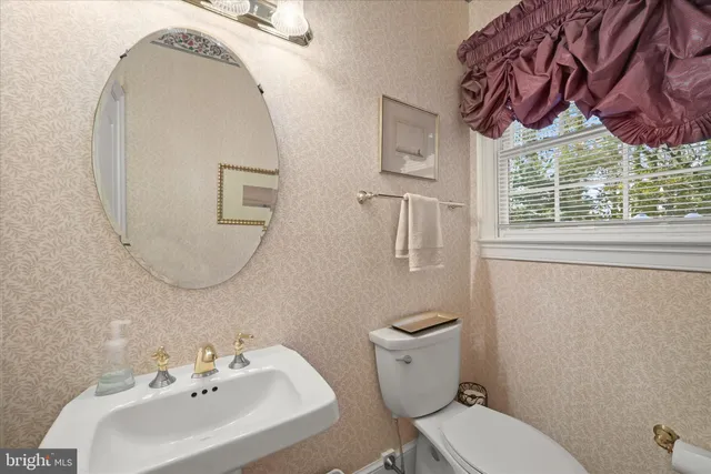 a large spacious bathroom with a tub sink and mirror