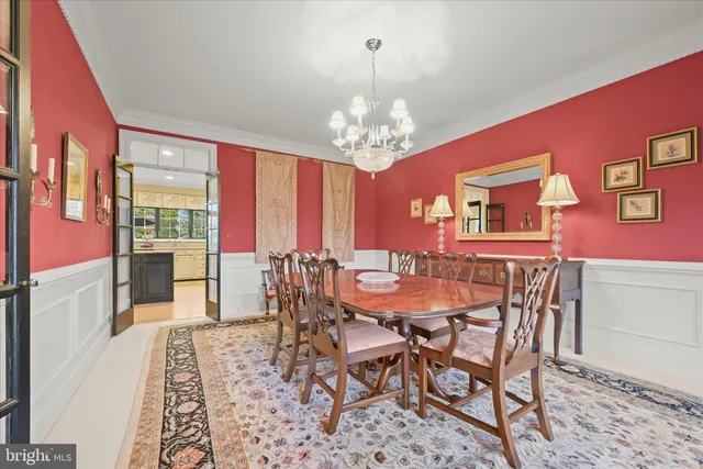 a view of a dining room with furniture a chandelier and wooden floor