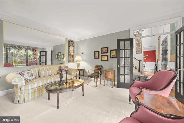 a kitchen with stainless steel appliances kitchen island granite countertop a table chairs and a refrigerator