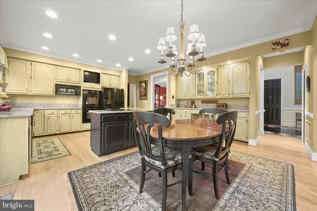 a kitchen with granite countertop a sink stainless steel appliances and cabinets