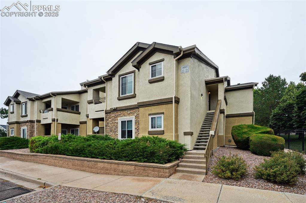 4007 Riviera Grove, Unit 103 Colorado Springs, CO 80922 - Photo 1 of 22 a view of multiple houses with a street