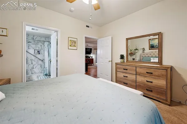 a bedroom with a bed and a dresser