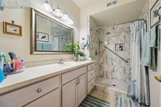 a bathroom with a double vanity sink mirror and shower