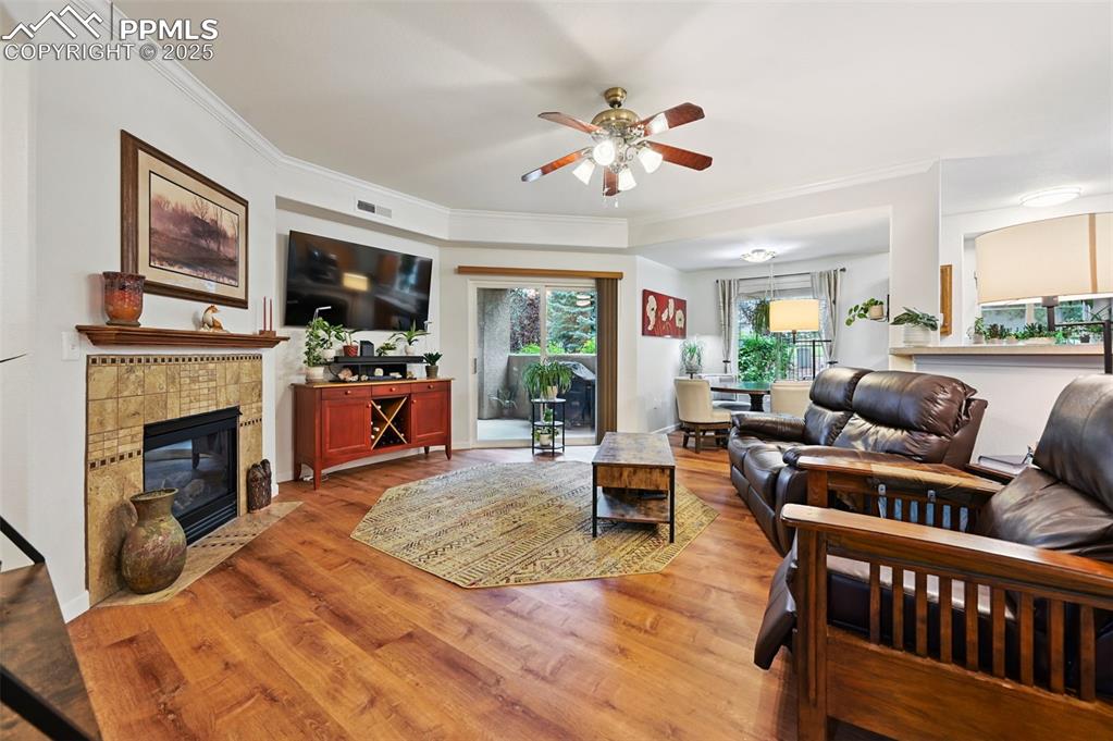 4007 Riviera Grove, Unit 103 Colorado Springs, CO 80922 - Photo 2 of 22 a living room with furniture a fireplace and a flat screen tv