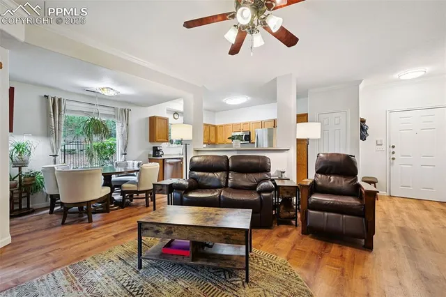 a living room with furniture and a wooden floor