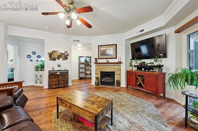 a living room with furniture a flat screen tv and a fireplace