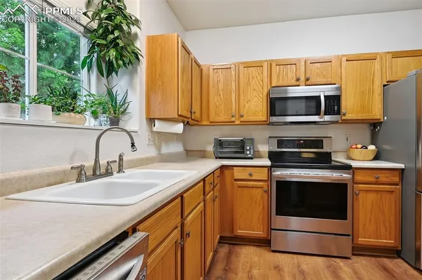 a kitchen with stainless steel appliances a stove a sink and a microwave