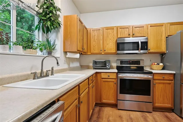 a kitchen with stainless steel appliances a stove a sink and a microwave