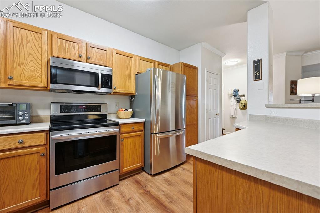 4007 Riviera Grove, Unit 103 Colorado Springs, CO 80922 - Photo 10 of 22 a kitchen with stainless steel appliances granite countertop a refrigerator microwave and stove top oven