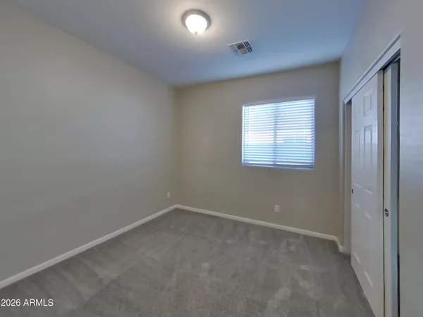 an empty room with closet area