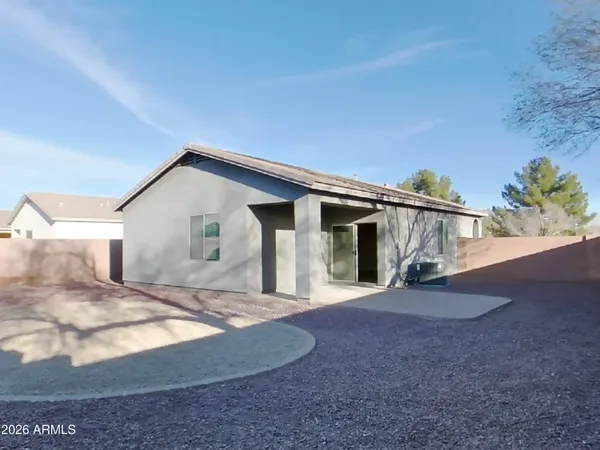 a view of a backyard with large trees